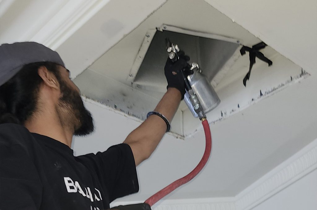 Technician cleaning the duct