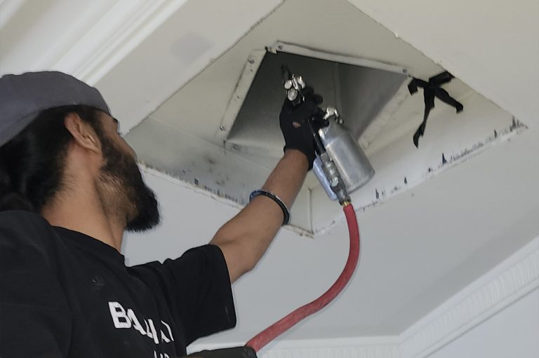 Technician cleaning the duct