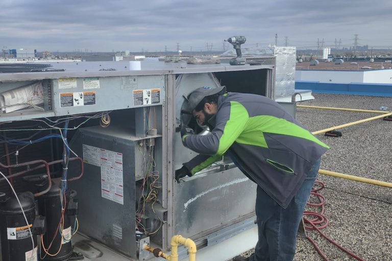 Technician working on Rooftop Unit