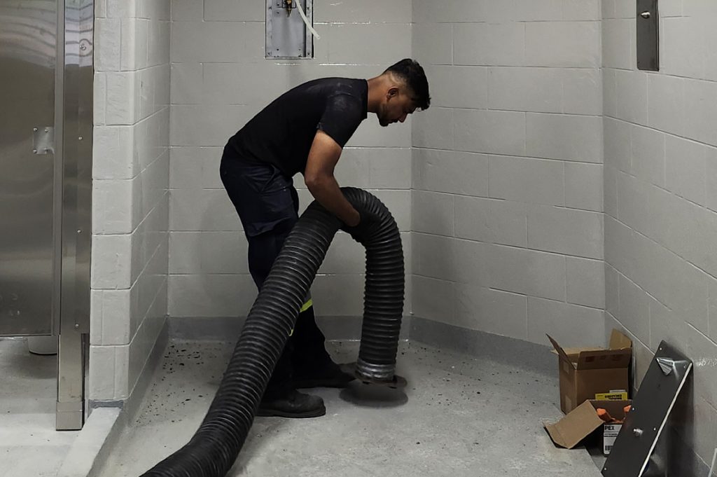 Technician attaching the vaccum